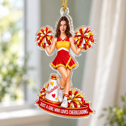 Custom-cut acrylic ornament of a cheerleader in red and yellow with pom-poms, a white megaphone, and a red name banner