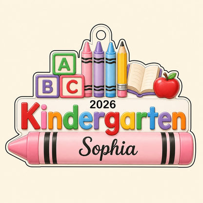 Clear acrylic ornament with ABC blocks, crayons, apple, open book and 'Kindergarten 2026' with a pink name banner