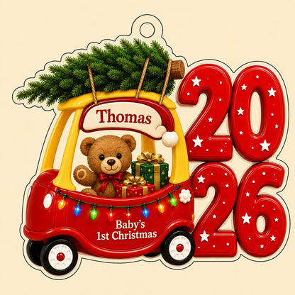 Red toy car with pine tree, teddy bear and gifts, "Baby's 1st Christmas" and 2026 star-pattern numbers on clear acrylic.