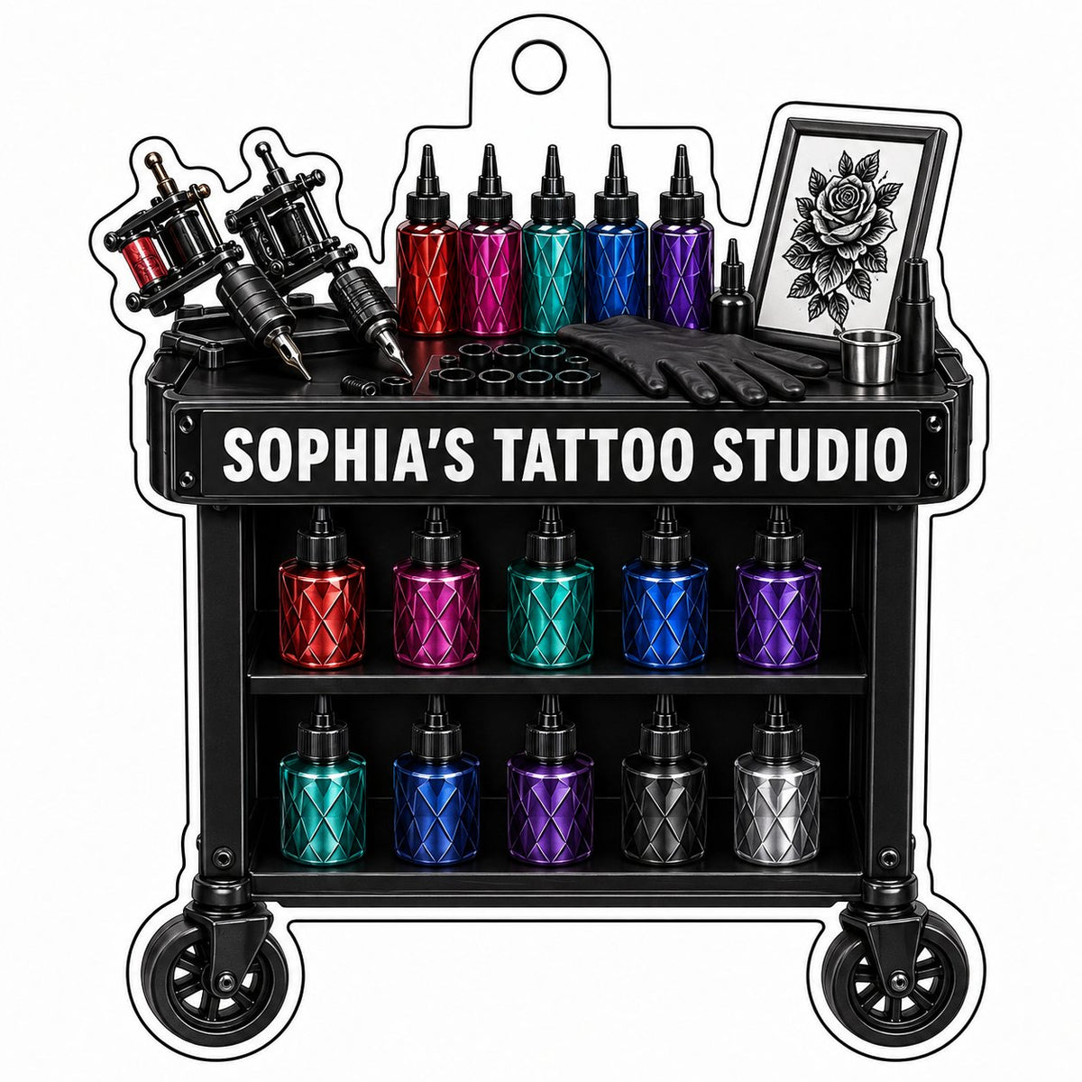Acrylic ornament shaped like a tattoo cart with machines, colorful inks, and 'SOPHIA'S TATTOO STUDIO' text.