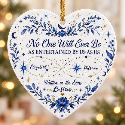 White heart ceramic ornament with blue florals, moons, stars, and “Written in the Stars Besties” with two names.