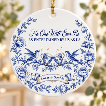Round ceramic ornament with blue toile border, two birds, clinking floral teacups and gold music notes with two names.