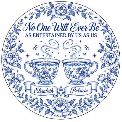 Round white ceramic ornament with blue floral border and two teacups, personalized with two names