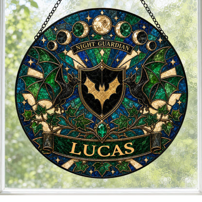 Round stained-glass suncatcher with gold bat shield, two black bats, moon phases, emerald gem, ivy and starbursts.