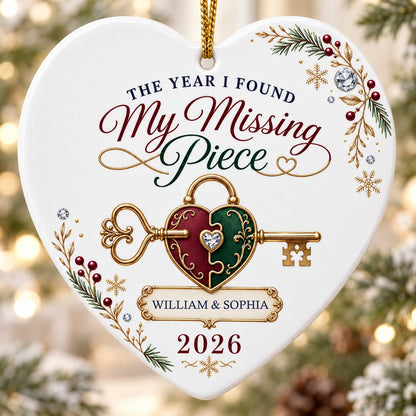Heart ceramic ornament with a gold key through a burgundy and green heart lock, pine sprigs, berries, and gold snowflake