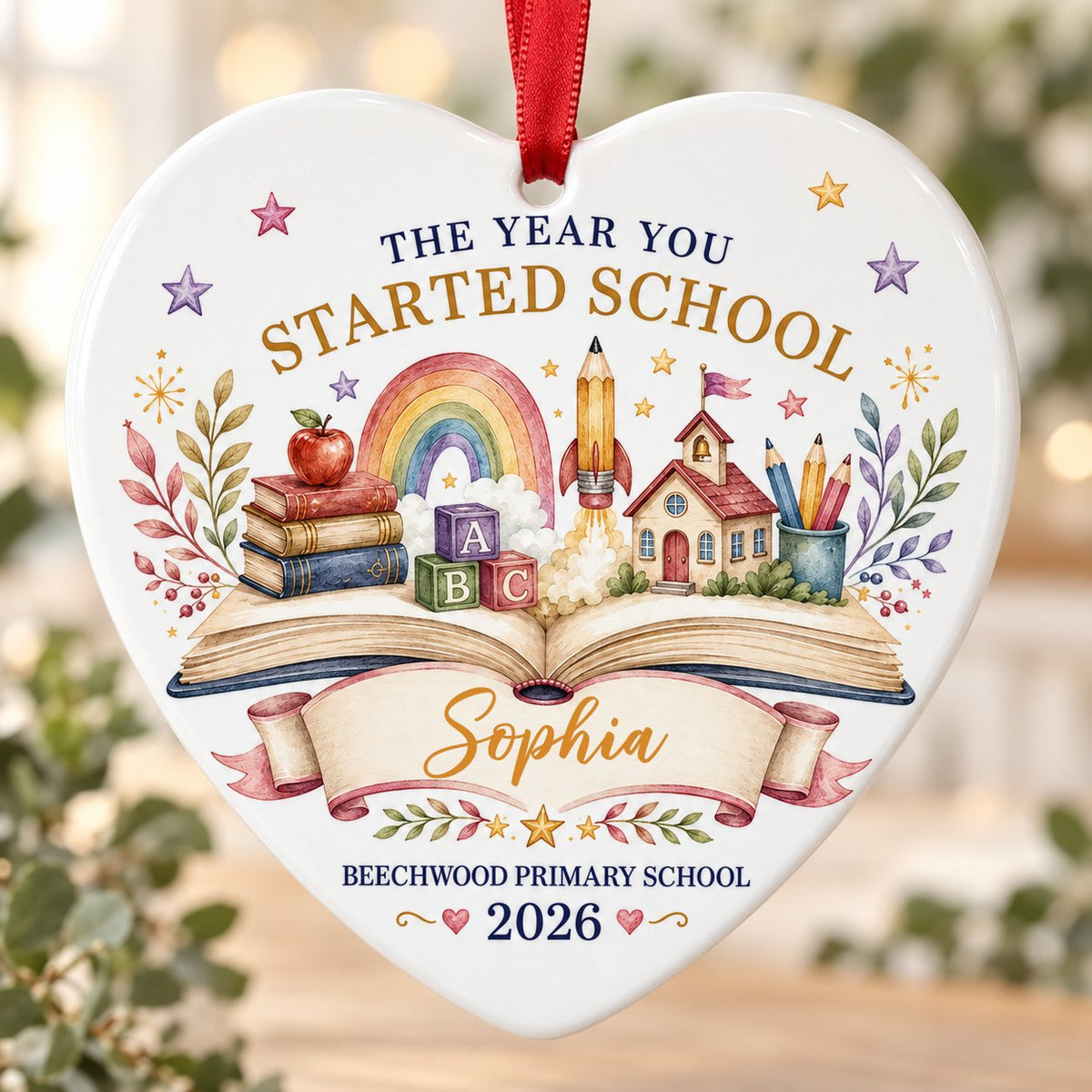 Heart ceramic ornament with an open book, rainbow, schoolhouse, ABC blocks and banner for name, school and year