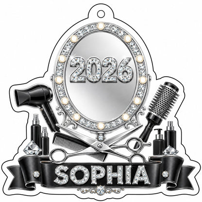 Clear acrylic ornament with a lit vanity mirror and salon tools, featuring SOPHIA and 2026 on a black banner.
