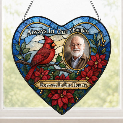 Heart stained glass suncatcher with red cardinal, oval memorial photo frame, and red poinsettias with green leaves.