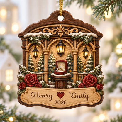 Arched wood ornament with three lanterns, pine trees, red roses, and an open ring box on a central pedestal.
