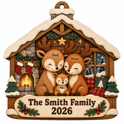 House-shaped wood ornament with deer family by a fireplace and snowy window, personalized with names and year.